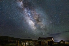 Milky Way over abandoned truck and buildings
