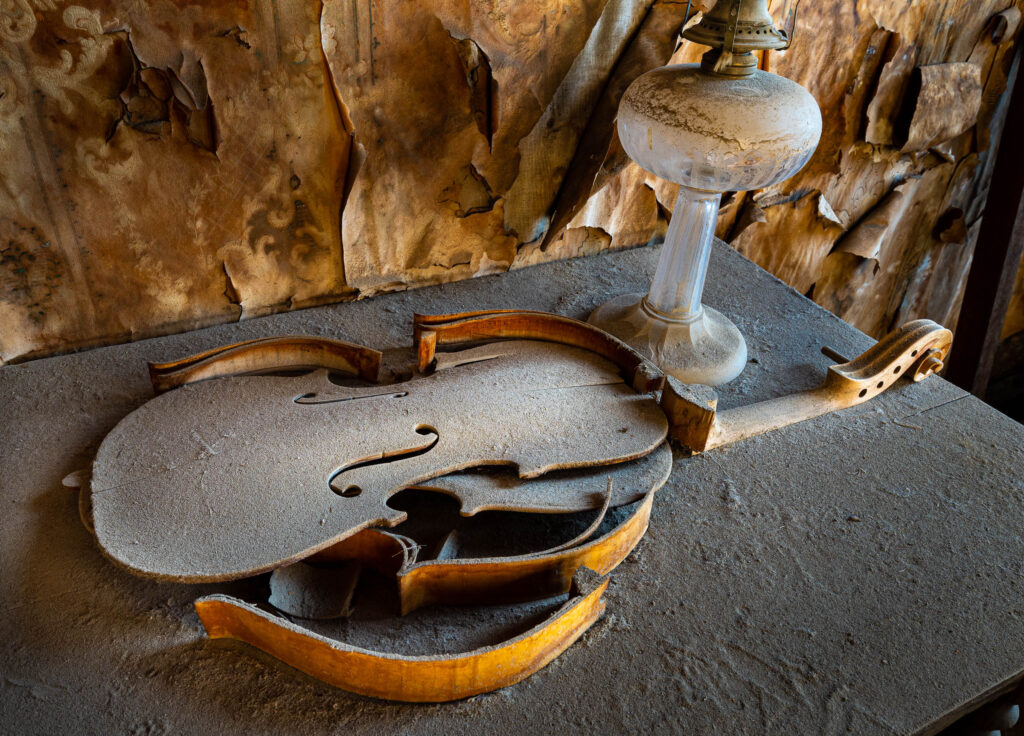 old violin abandoned in Ghost Town